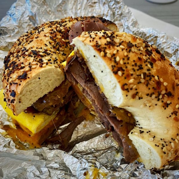 A sliced everything bagel from 6th Street Deli, filled with roast beef, egg, and cheese.